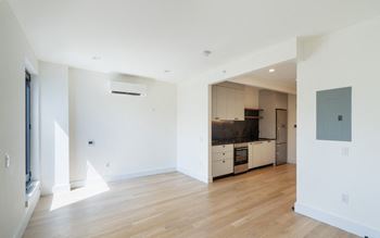 an empty living room and kitchen in a house